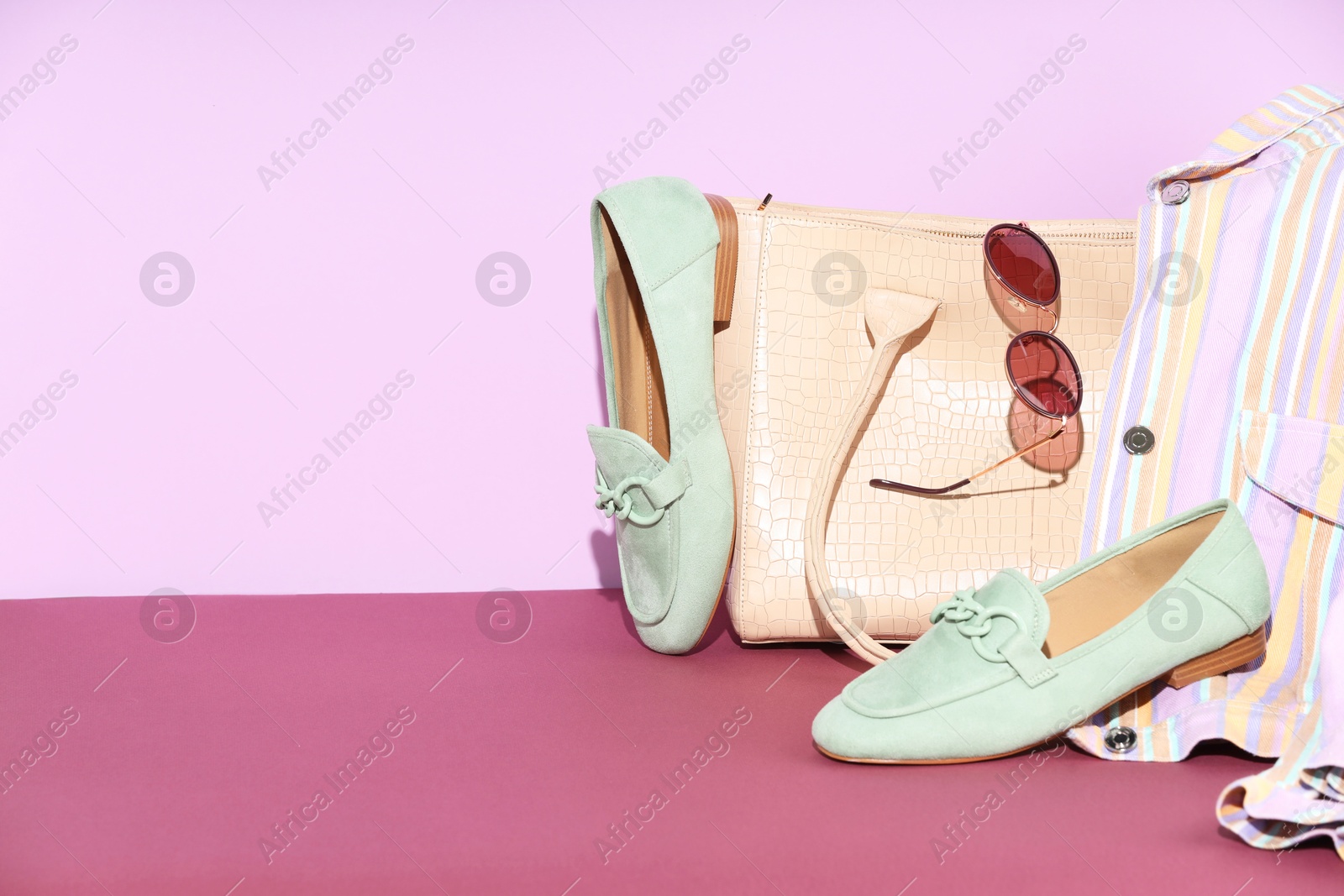 Photo of Clothes, shoes, bag and sunglasses on color background, space for text