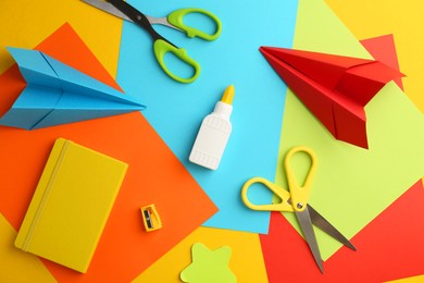 Photo of Flat lay composition with glue, scissors and other stationery on color background