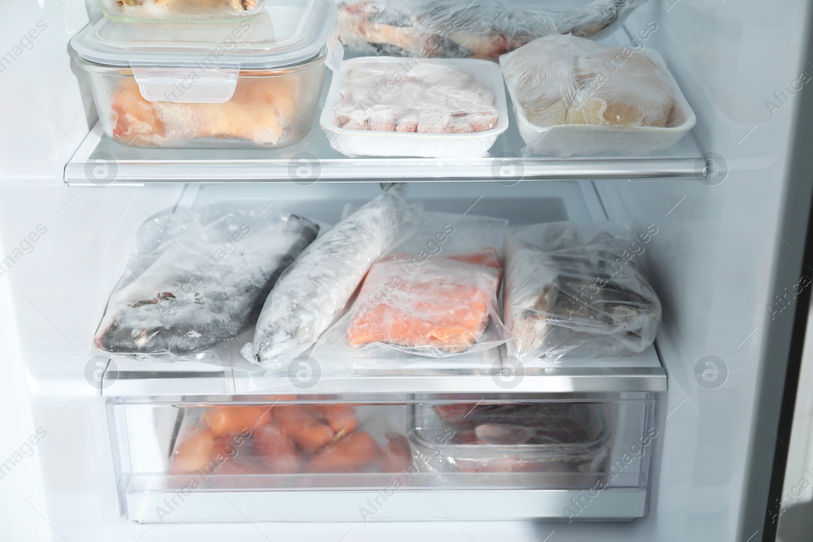 Photo of Different frozen meat and fish products in fridge