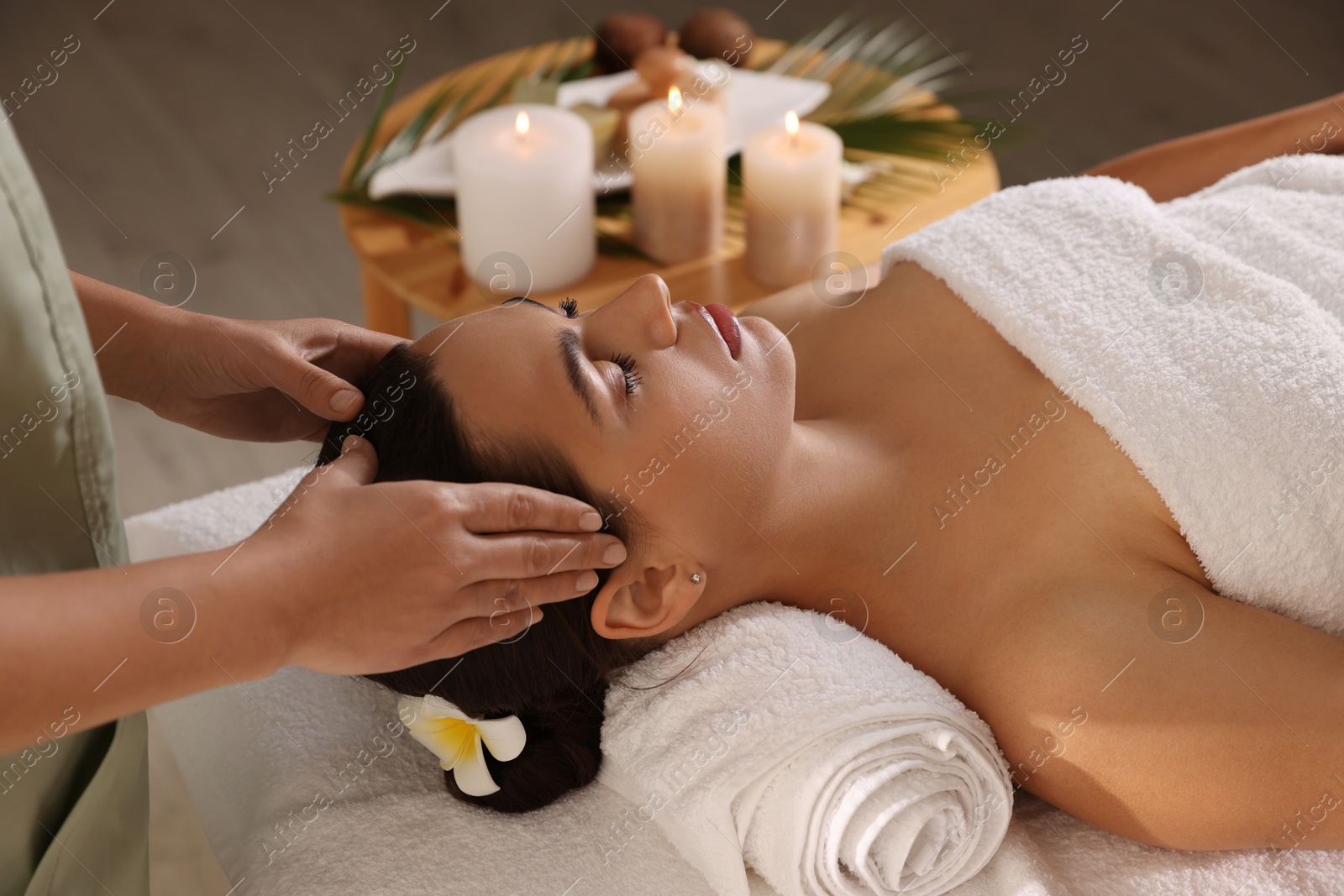 Photo of Young woman receiving massage in spa salon