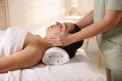 Photo of Young woman receiving massage in spa salon