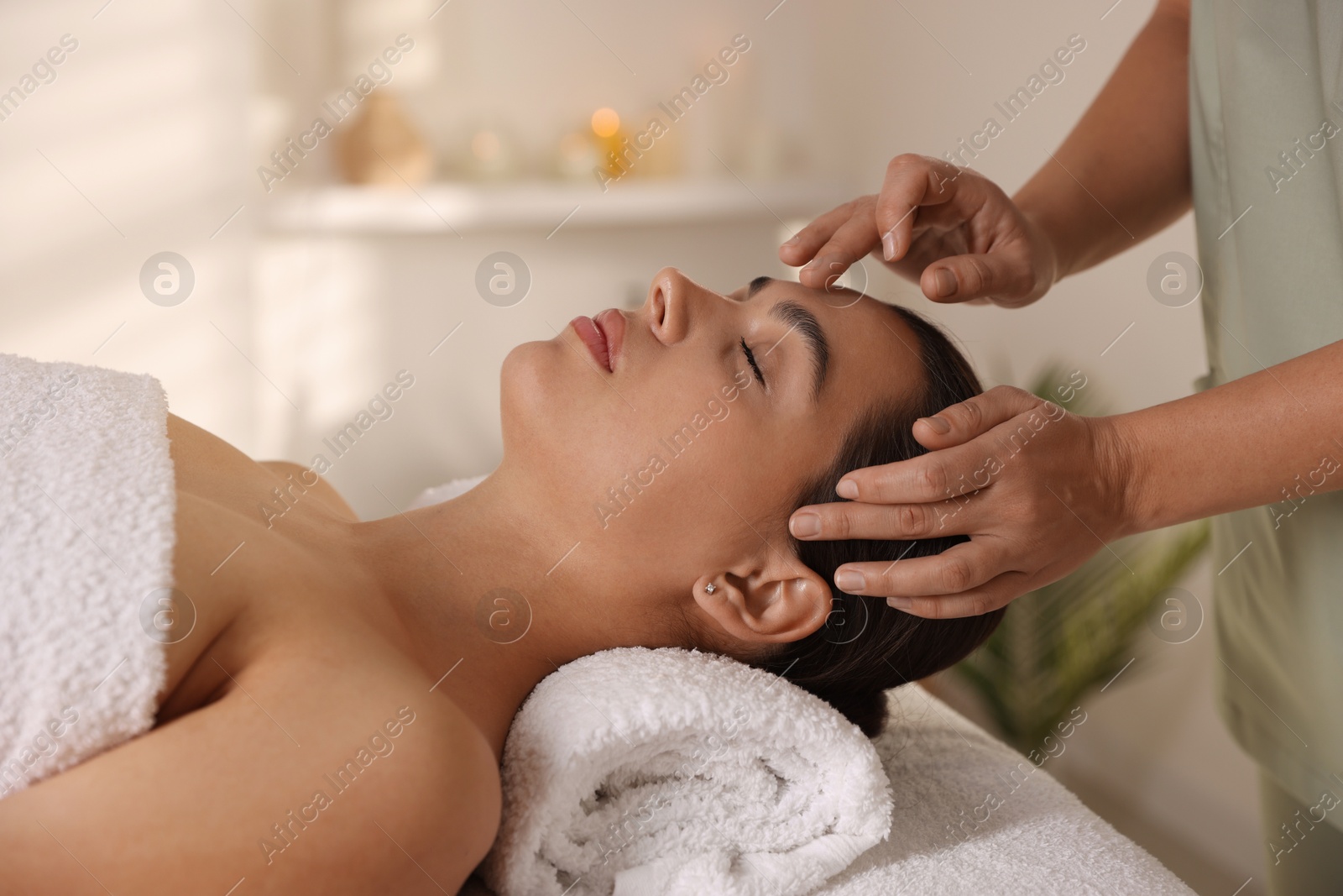 Photo of Woman receiving face massage in spa salon