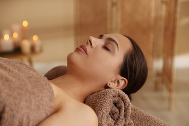 Woman lying on massage table in spa salon