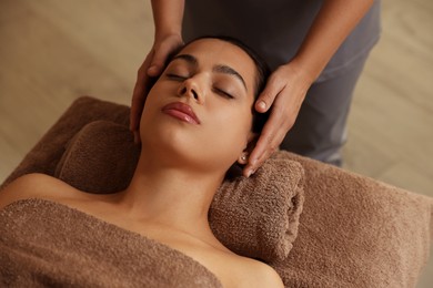 Young woman receiving massage in spa salon, above view