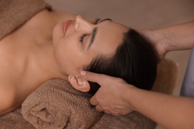 Photo of Young woman receiving massage in spa salon