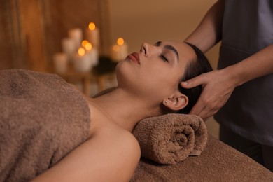 Photo of Young woman receiving massage in spa salon