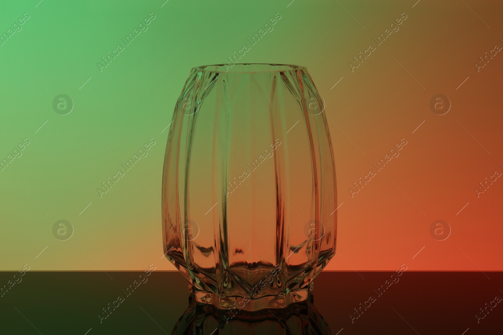 Photo of Empty glass vase on table, color tone effect