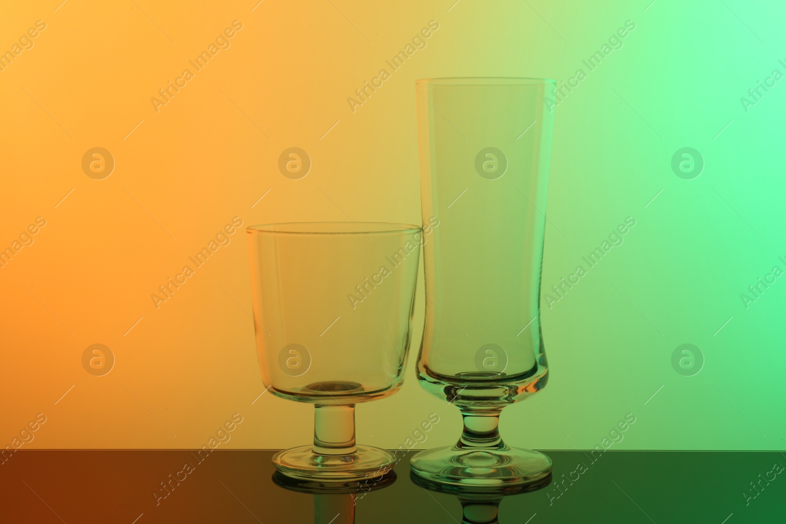 Photo of Empty glasses on table, color tone effect