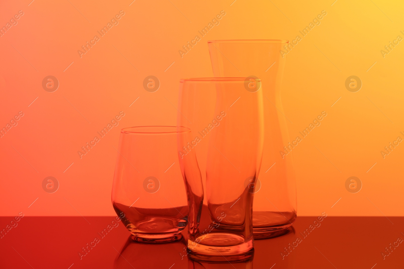 Photo of Empty glass and jug on table, color tone effect