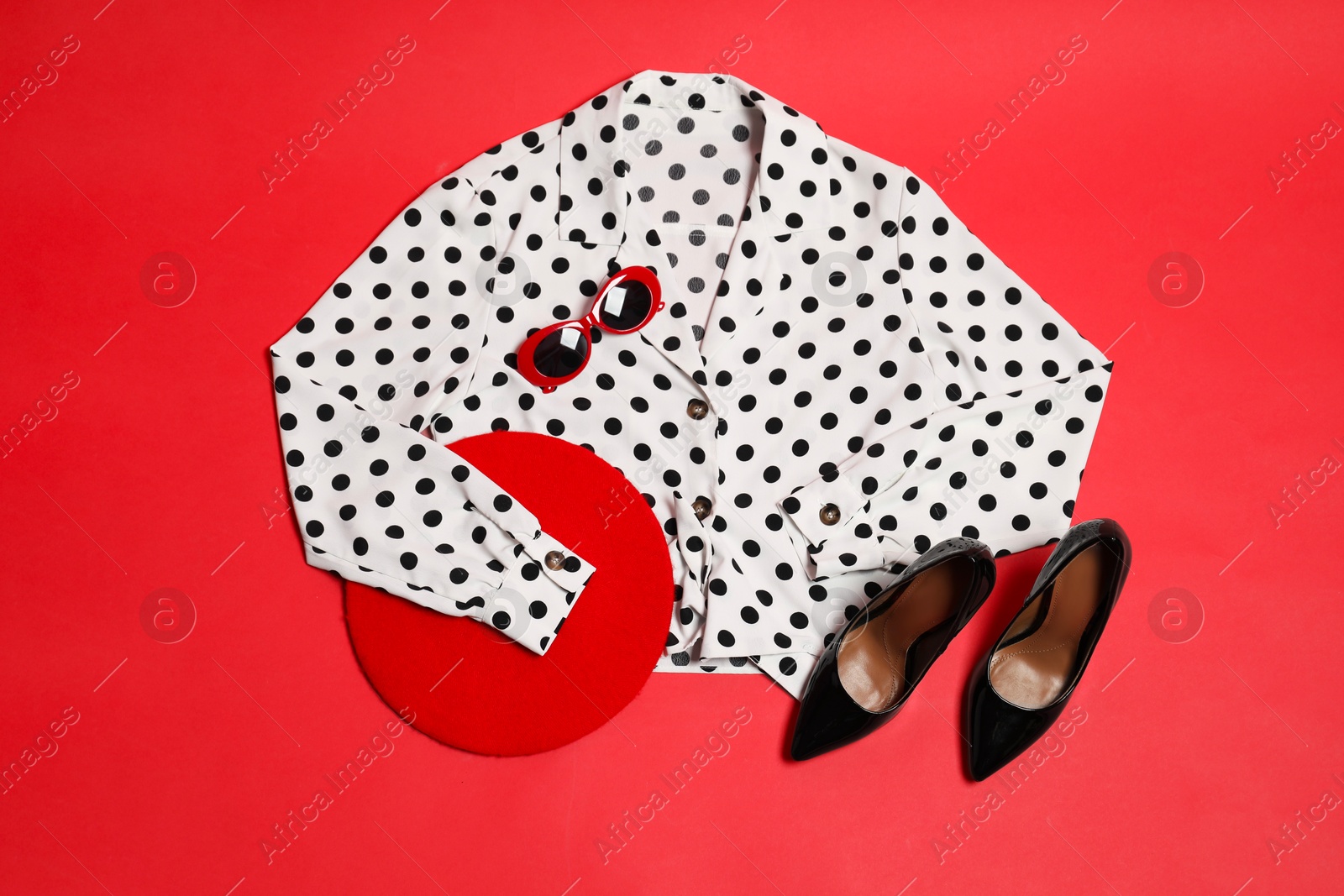 Photo of Retro styled outfit on red background, flat lay