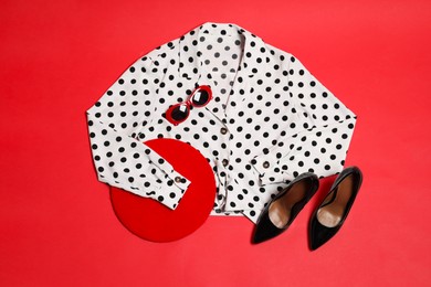 Photo of Retro styled outfit on red background, flat lay