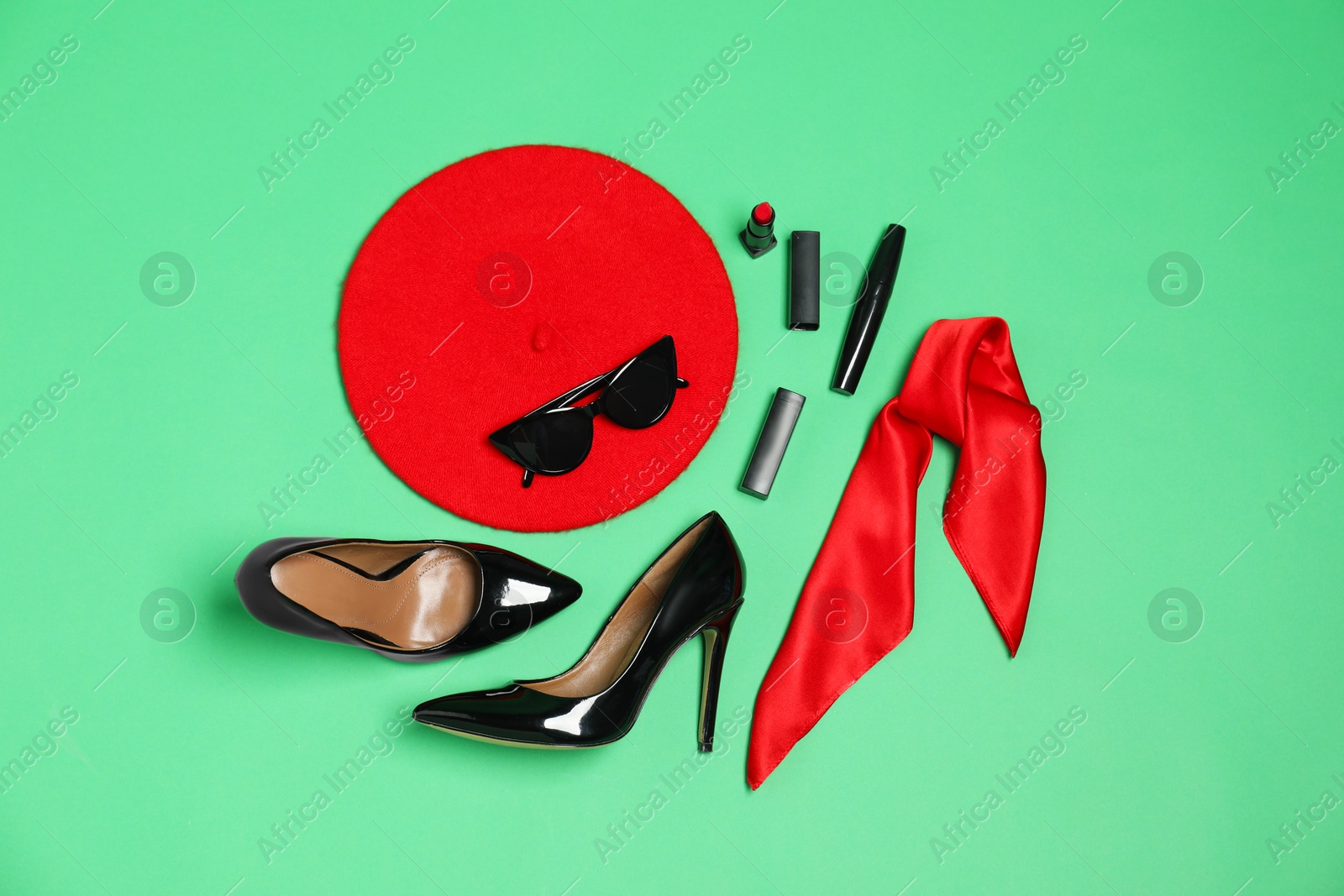 Photo of Stylish accessories on green background, flat lay