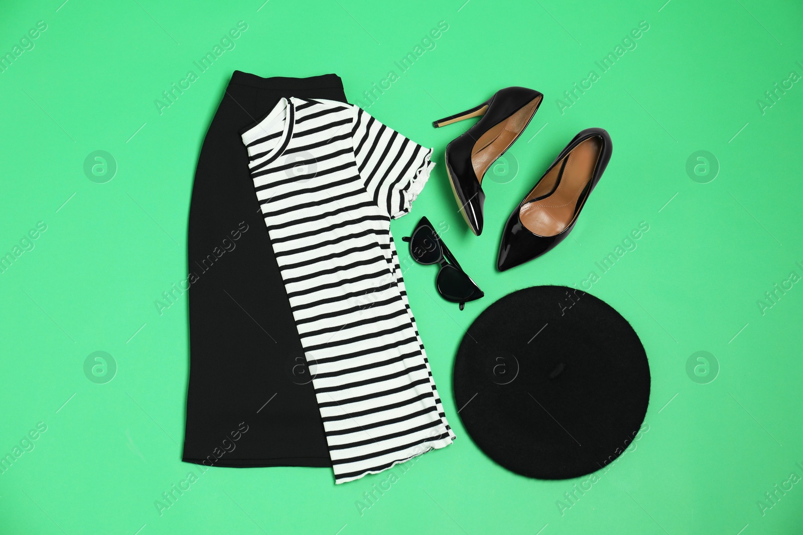 Photo of Retro styled outfit on green background, flat lay