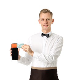 Photo of Happy waiter with payment terminal and debit card on white background