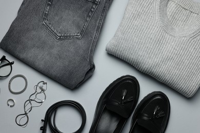 Photo of Stylish clothes and accessories on grey background, flat lay. Fashion concept