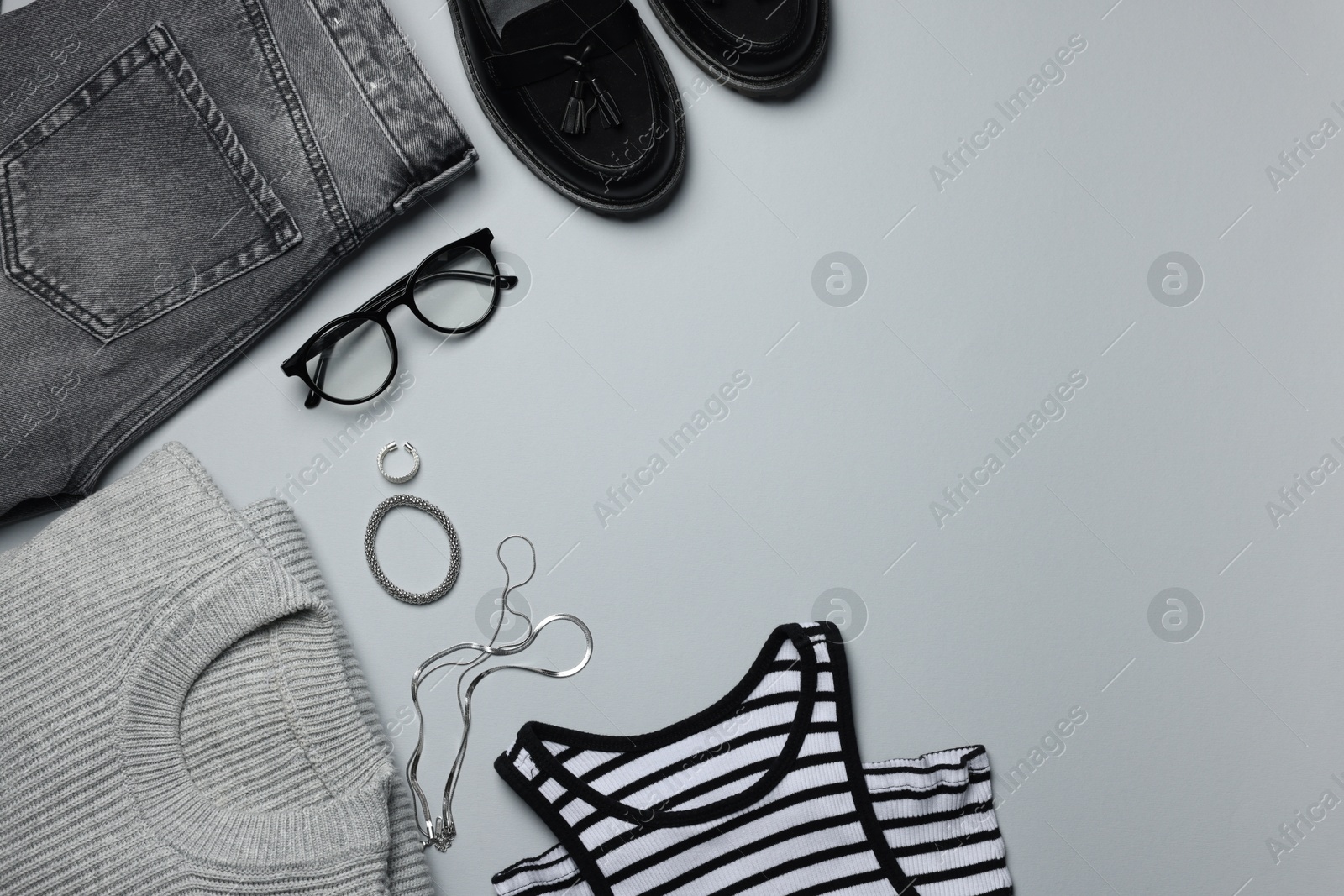 Photo of Fashion concept. Stylish clothes and accessories on grey background, flat lay. Space for text