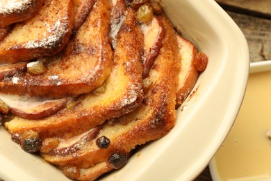 Photo of Freshly baked bread pudding in baking dish on table, top view