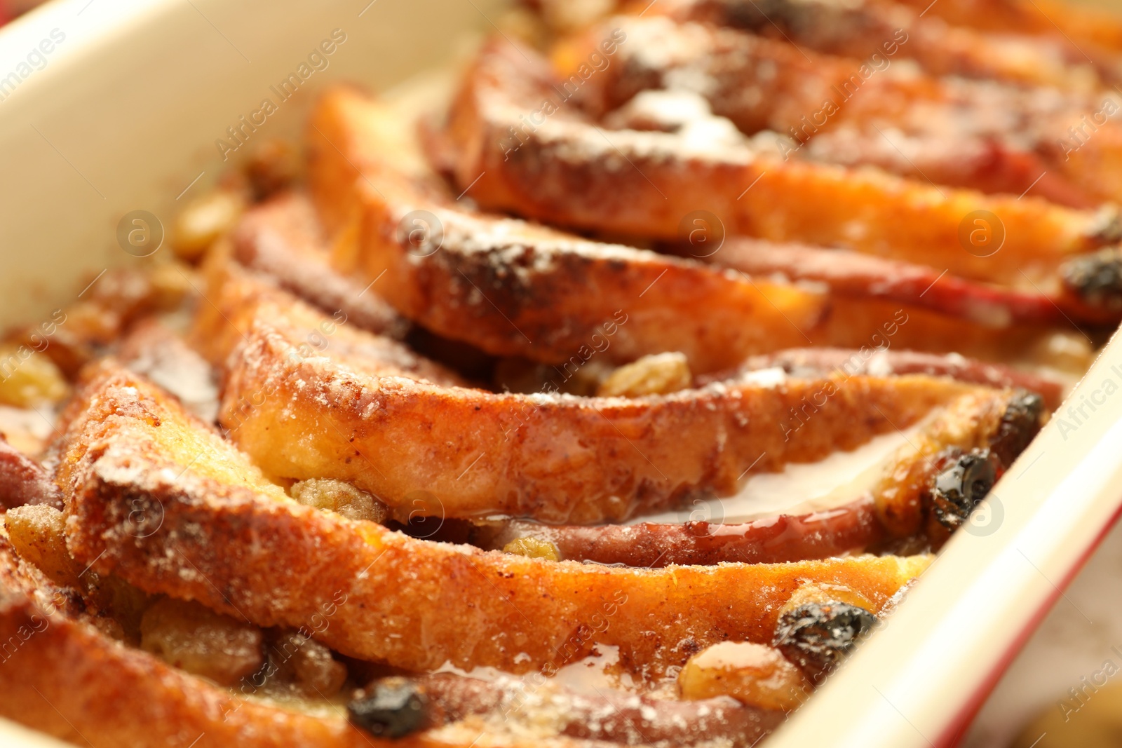 Photo of Freshly baked bread pudding in baking dish, closeup