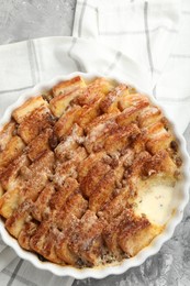 Photo of Delicious bread pudding with raisins and cinnamon on grey table, top view