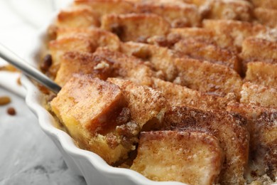 Photo of Delicious bread pudding with raisins and cinnamon on table, closeup