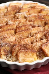 Photo of Delicious bread pudding with raisins and cinnamon on table, closeup