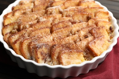 Photo of Delicious bread pudding with raisins and cinnamon on table, closeup