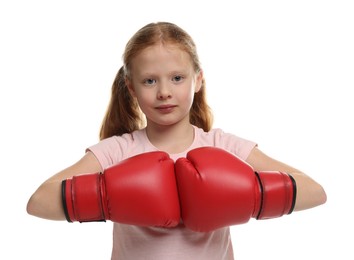 Photo of Cute little girl with boxing gloves on white background