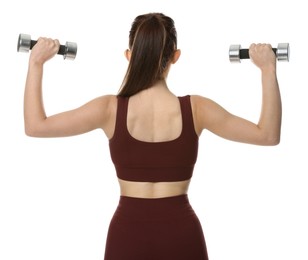 Woman in sportswear exercising with dumbbells on white background, back view