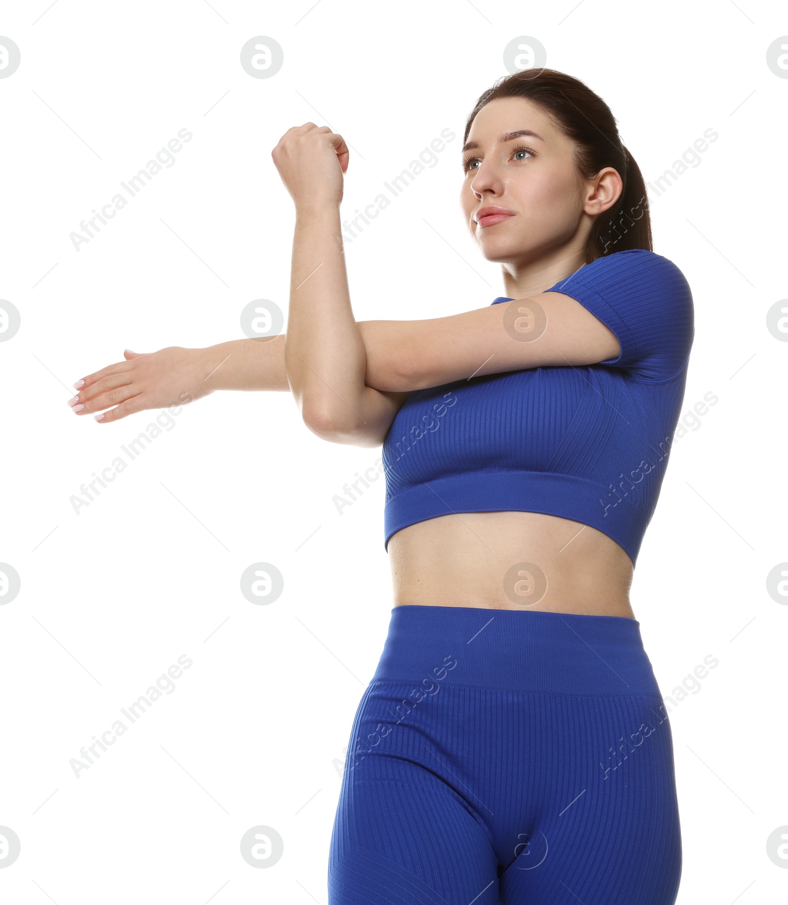 Photo of Woman in sportswear exercising on white background