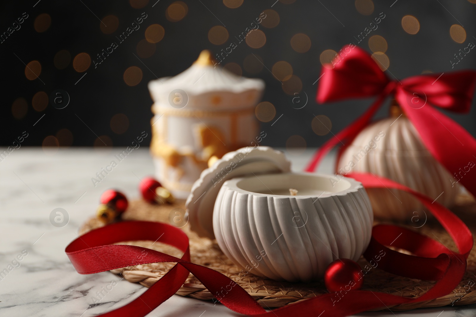 Photo of Soy wax candles on white marble table, closeup. Beautiful Christmas decor