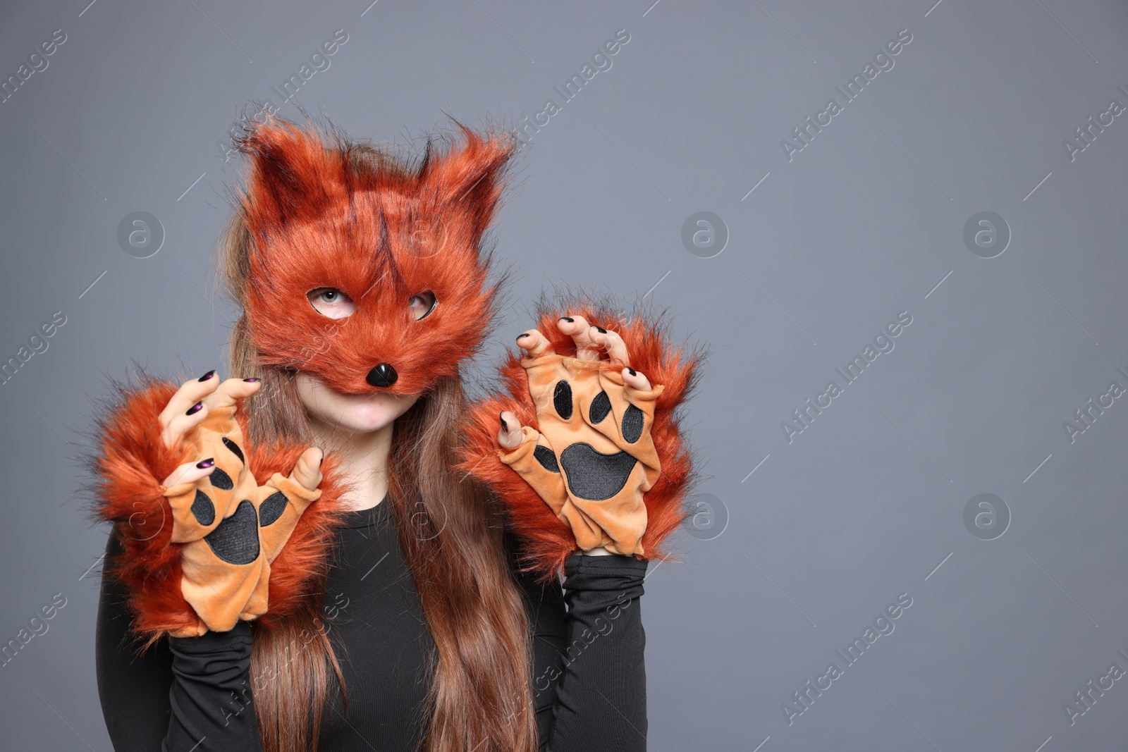 Photo of Quadrobics. Girl wearing fox mask and gloves on grey background, space for text