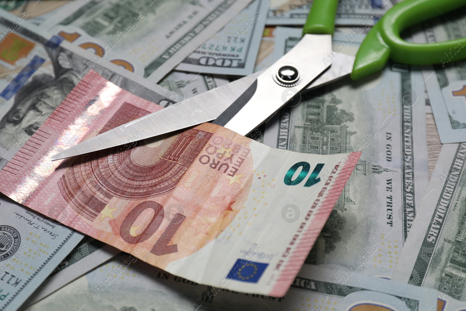 Photo of Different banknotes and scissors as background, closeup