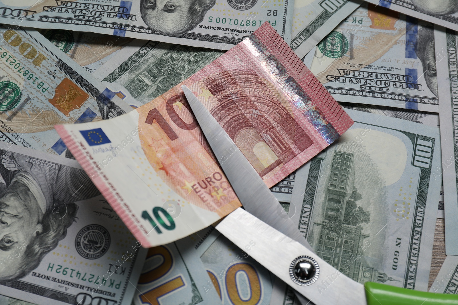 Photo of Different banknotes and scissors as background, top view