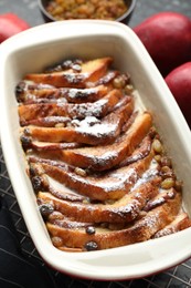 Photo of Freshly baked bread pudding in baking dish on table, closeup