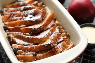 Freshly baked bread pudding in baking dish on table, closeup