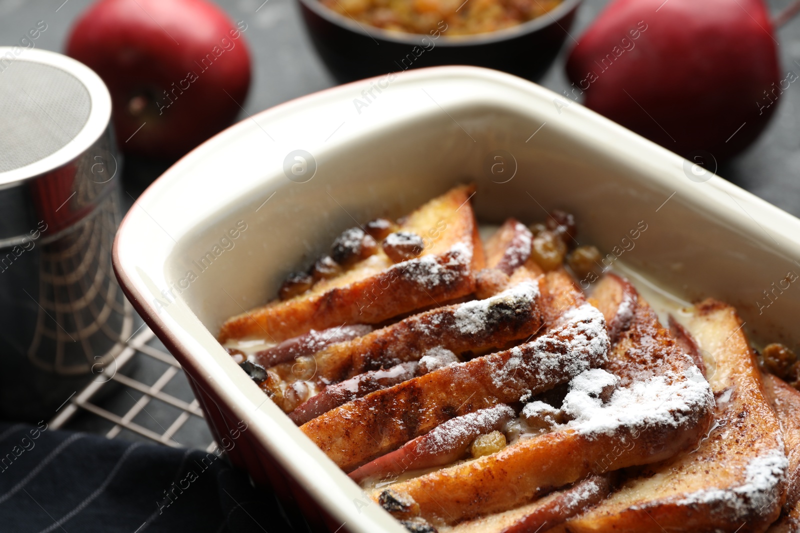 Photo of Freshly baked bread pudding in baking dish on table, closeup