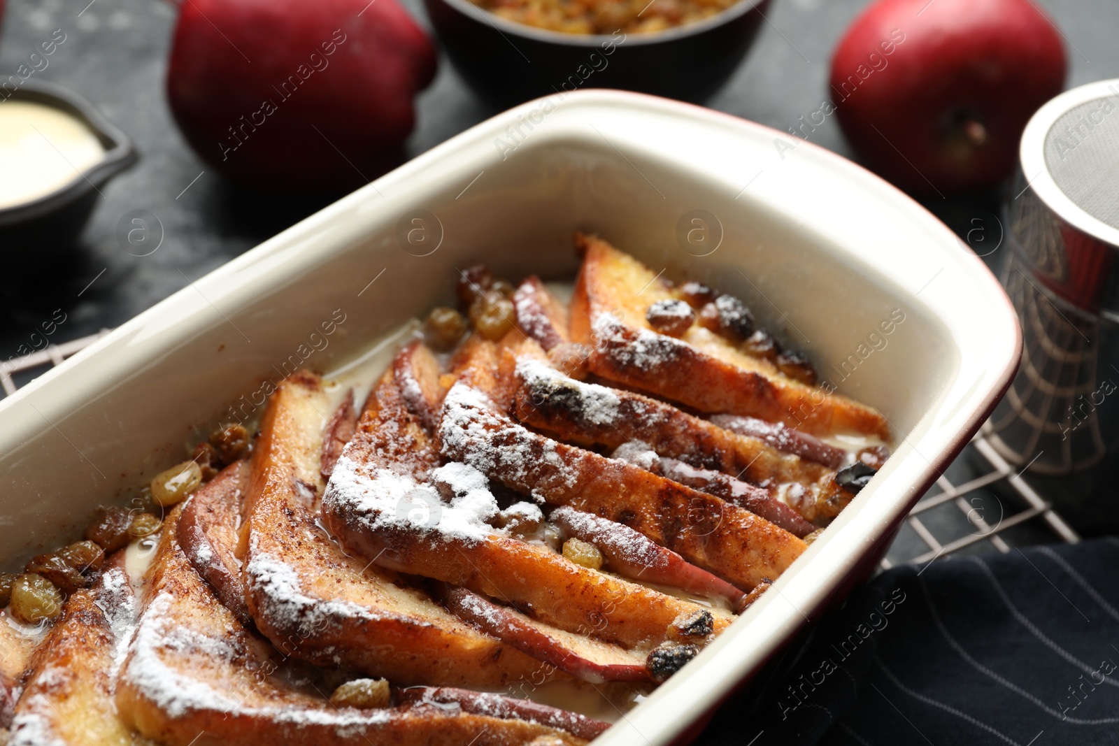 Photo of Freshly baked bread pudding in baking dish on table, closeup