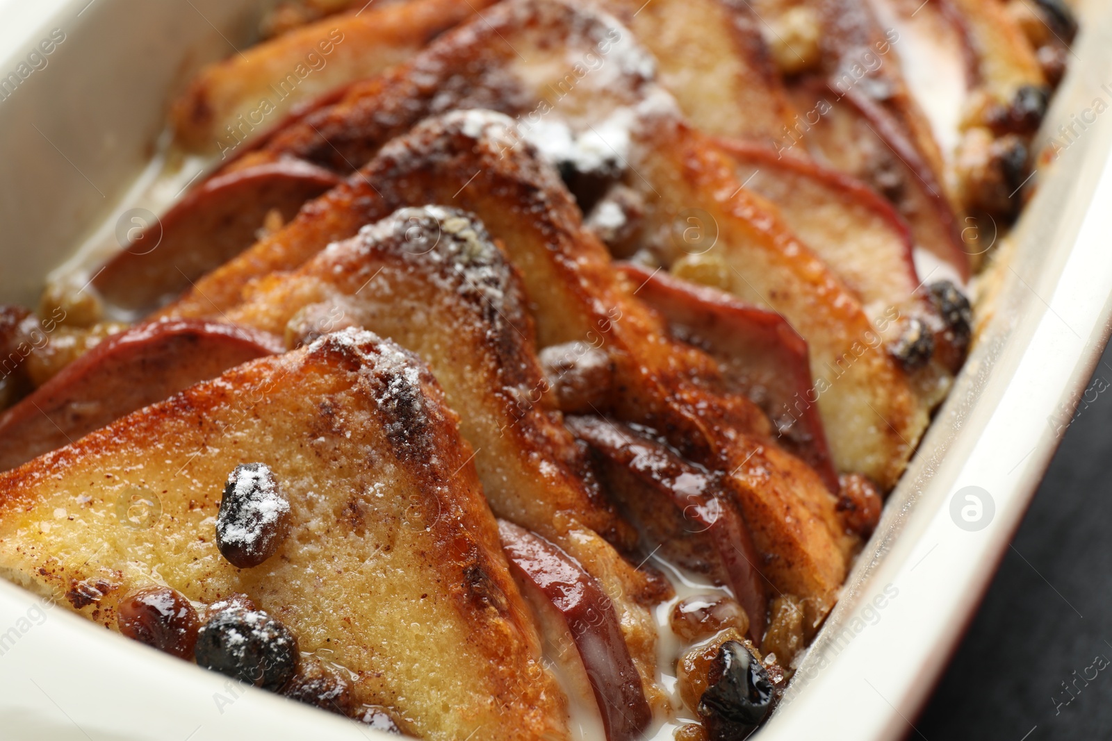 Photo of Freshly baked bread pudding in baking dish, closeup