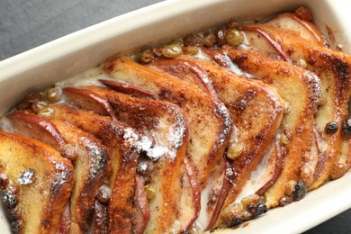 Photo of Freshly baked bread pudding in baking dish on grey table, top view