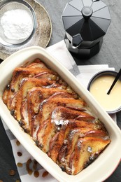 Photo of Flat lay composition with freshly baked bread pudding on dark textured table