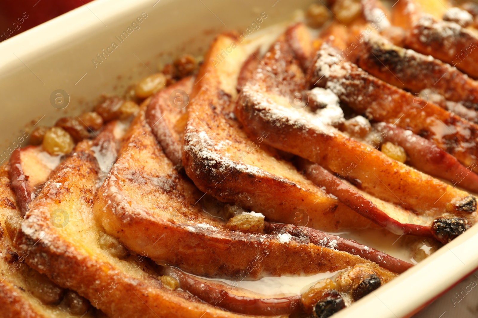 Photo of Freshly baked bread pudding in baking dish, closeup