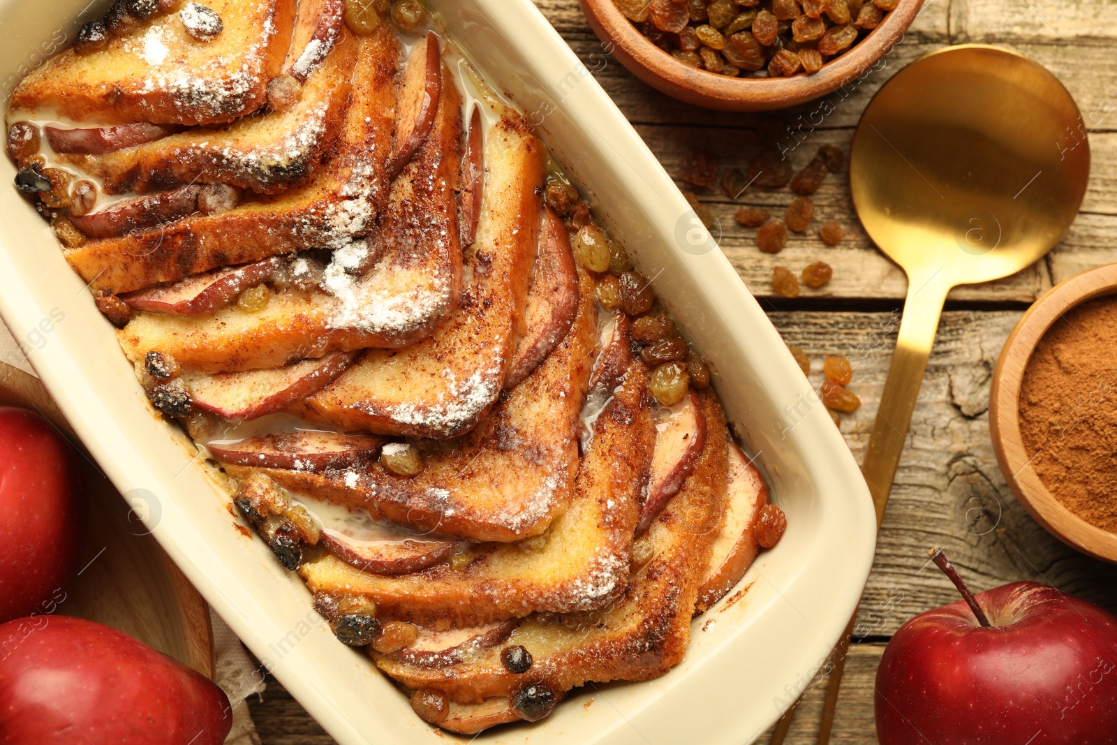 Photo of Flat lay composition with tasty bread pudding on wooden table