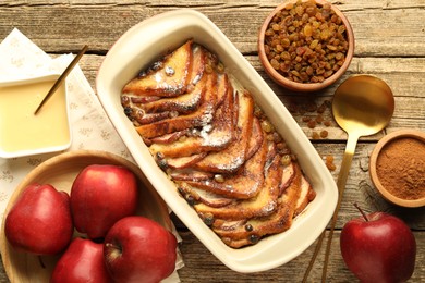 Photo of Flat lay composition with tasty bread pudding on wooden table