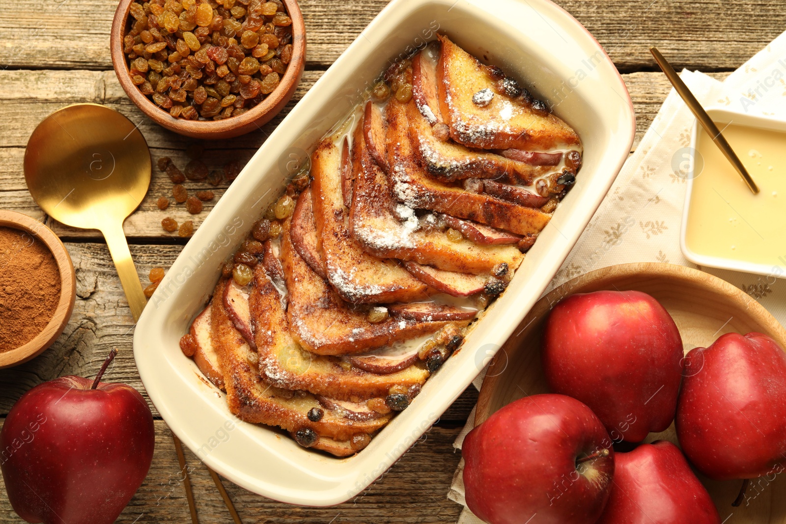 Photo of Flat lay composition with tasty bread pudding on wooden table