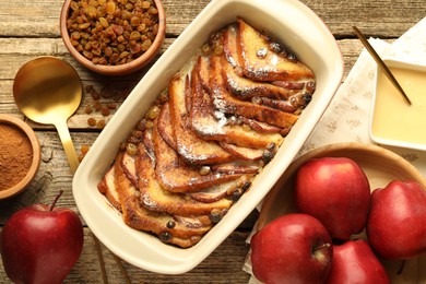 Photo of Flat lay composition with tasty bread pudding on wooden table