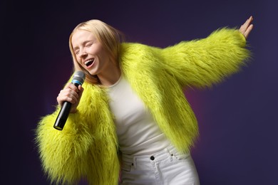 Photo of Talented singer in faux fur performing on dark background