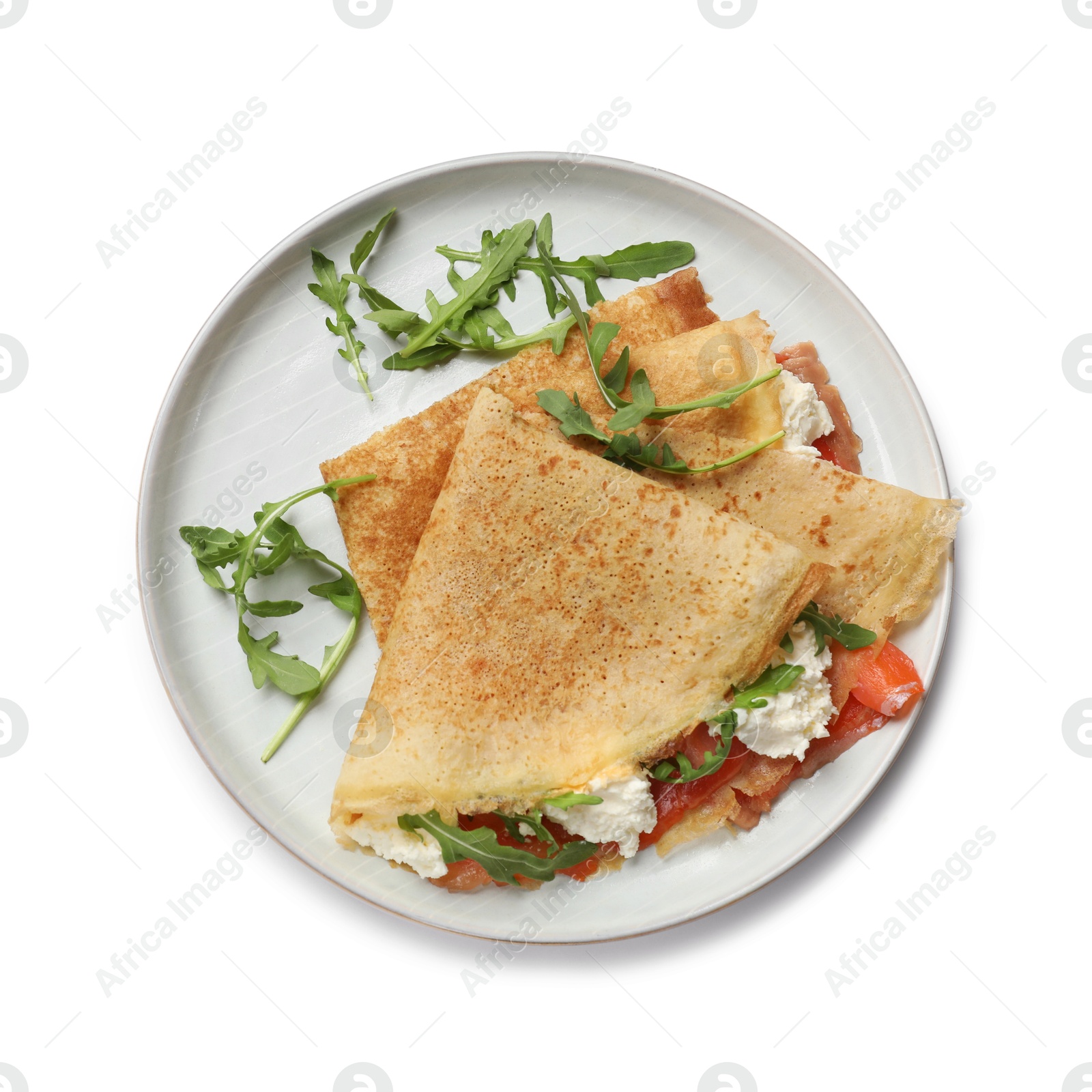 Photo of Delicious crepes with salmon, cream cheese and arugula isolated on white, top view