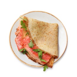 Photo of Delicious crepe with salmon and arugula isolated on white, top view