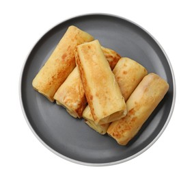 Photo of Many delicious rolled crepes isolated on white, top view