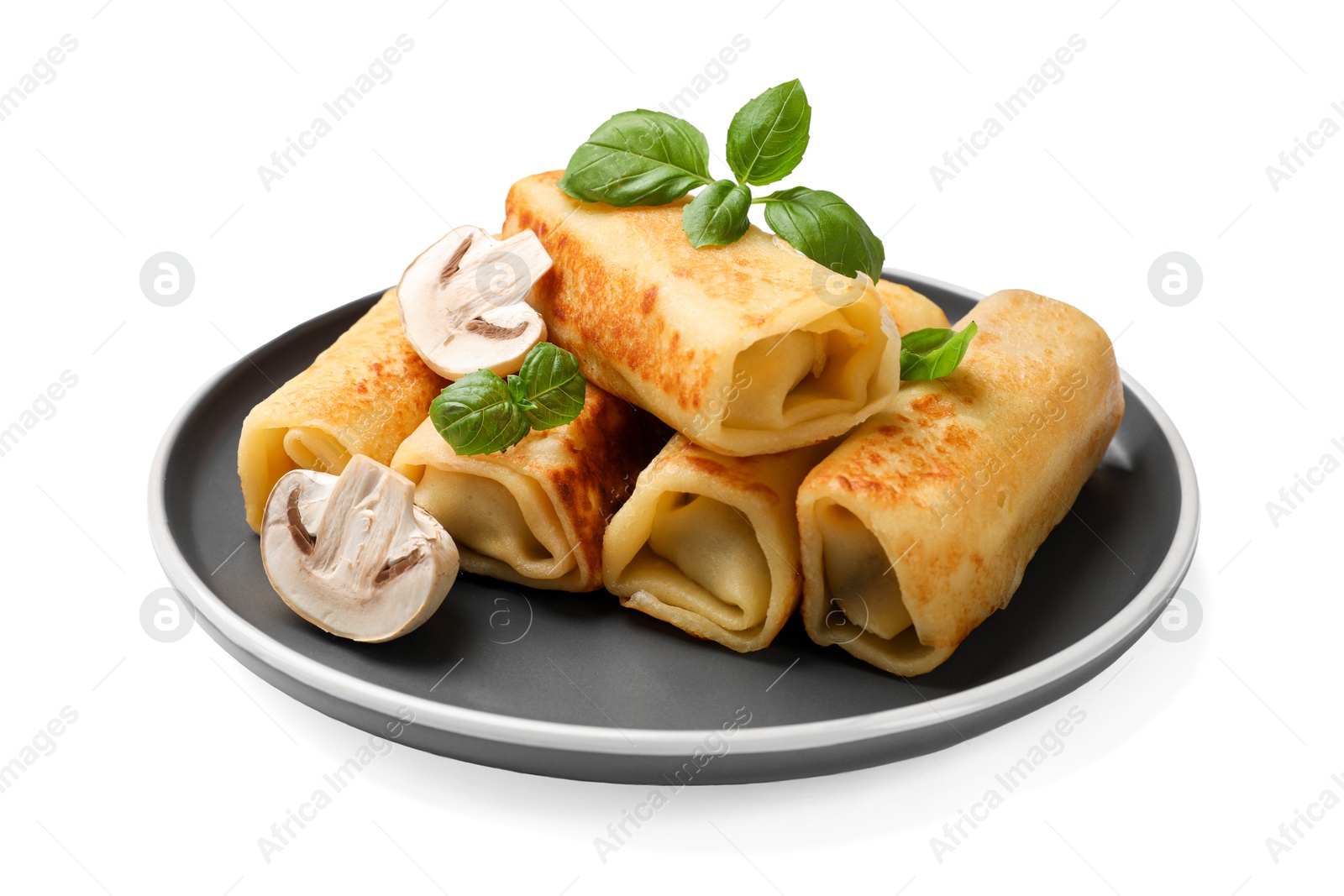 Photo of Delicious rolled crepes with mushrooms and basil isolated on white